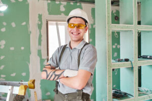 Skilled contractor from the best remodeling company in Santa Clarita posing in front of a newly renovated wall