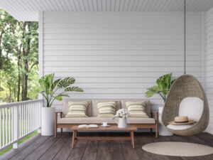 A porch with a swing and a sofa, creating a cozy space to relax outdoors.